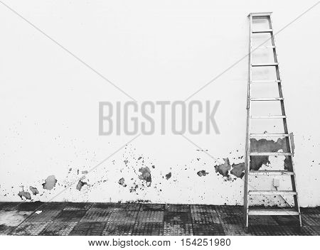 a ladder leaning against a concrete wall