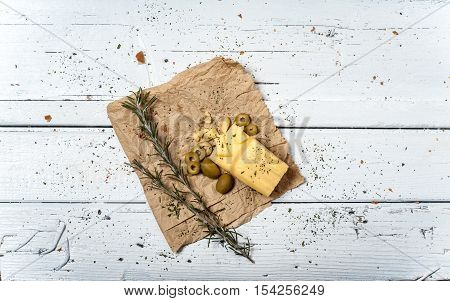 Olives and cheese on white retro table