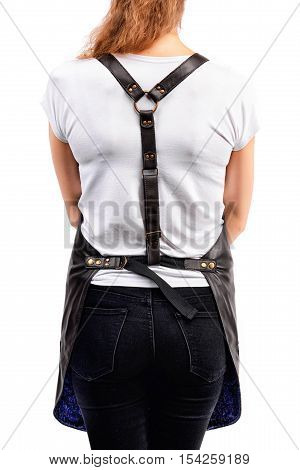 Young redhaired woman chef or waiter posing, wearing apron and white t-shirt isolated on white background
