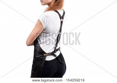 Young redhaired woman chef or waiter posing, wearing apron and white t-shirt isolated on white background