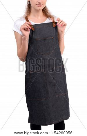 Young redhaired woman chef or waiter posing, wearing apron and white t-shirt isolated on white background
