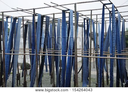The famous dyed fabrics hanging outside to dry in tongxiang wuzhen scenic town west view in Zhejiang province China on a overcast day.