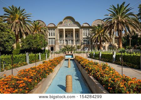 Persian garden of Eram with its beautiful pavilion traditional Iranian fountain system and Palm trees in city of Shiraz Iran.
