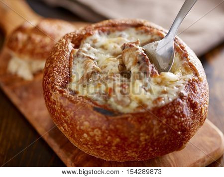 eating philly cheese steak sourdough breadbowl