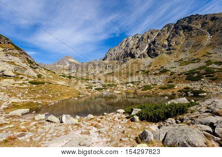 Beautiful Pleso nad Skokom in Mlynicka dolina on the way to Bystre sedlo - in slovakian high Tatra mountains. Summer panorama with great weather and blue sky