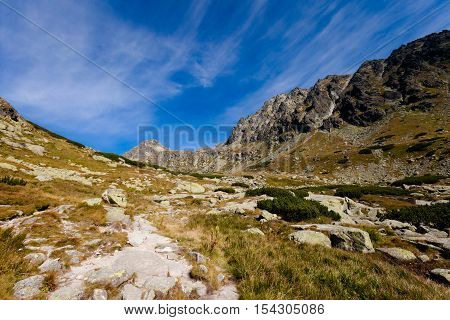 Beautiful Pleso nad Skokom in Mlynicka dolina on the way to Bystre sedlo - in slovakian high Tatra mountains. Summer panorama with great weather and blue sky