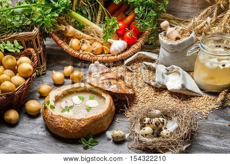 Fresh vegetables and homemade soup on wooden table