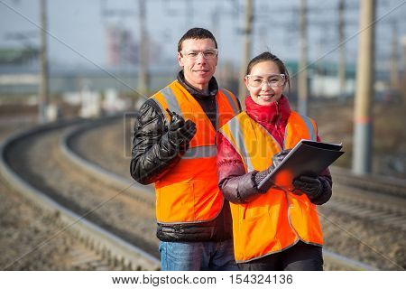 Man and a woman railroad workers maintaing railway
