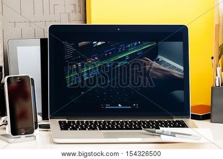 PARIS FRANCE - OCT 28 2016: Apple Computers website on new MacBook Pro Retina with OLED Touch bar in geek creative room showcasing Apple Keynote presentation of video editing on MAcBook pro