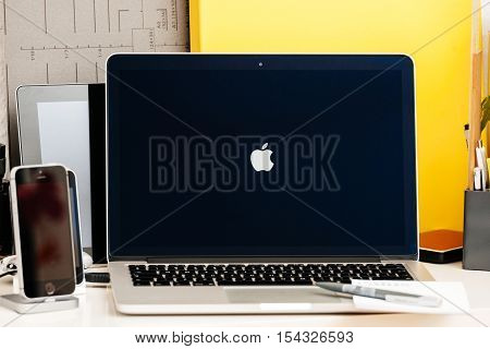 PARIS FRANCE - OCT 28 2016: Apple Computers website on new MacBook Pro Retina with OLED Touch bar in geek creative room showcasing Apple Keynote - logotype Apple computers on screen