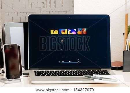 PARIS FRANCE - OCT 28 2016: Apple Computers website on new MacBook Pro Retina with OLED Touch bar in geek creative room showcasing Apple Keynote presentation of laptop range by Tim Cook