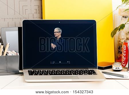 PARIS FRANCE - OCT 28 2016: Apple Computers website on new MacBook Pro Retina with OLED Touch bar in geek creative room showcasing Apple Keynote presentation of Tim Cook saluting audience