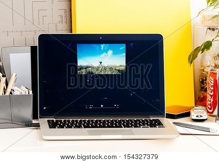 PARIS FRANCE - OCT 28 2016: Apple Computers website on new MacBook Pro Retina with OLED Touch bar in geek creative room showcasing Apple Keynote presentation of iPhone 7 plus photographs by Tim Cook