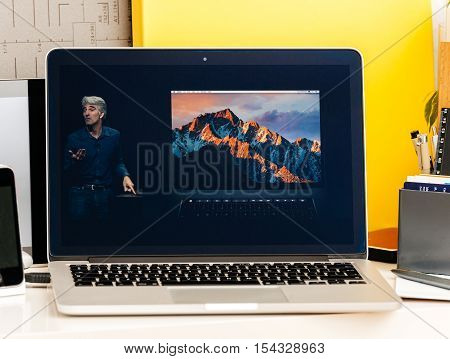 PARIS FRANCE - OCT 28 2016: Apple Computers website on new MacBook Pro Retina with OLED Touch bar in geek creative room showcasing Apple Keynote presentation Craig Federighi talking about new MacBook Pro