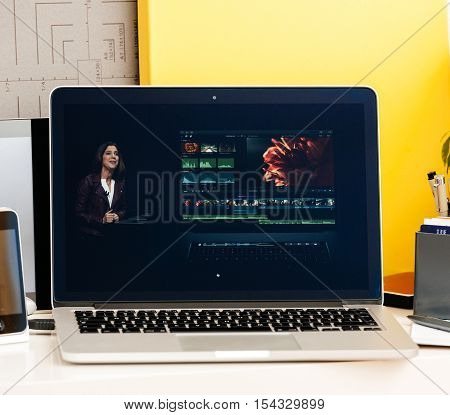 PARIS FRANCE - OCT 28 2016: Apple Computers website on new MacBook Pro Retina with OLED Touch bar in geek creative room showcasing Apple Keynote presentation of OLE and Final Cut Pro software