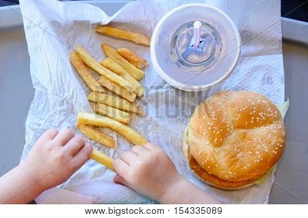Above View Of Little Girl Ready To Eat Fast Food