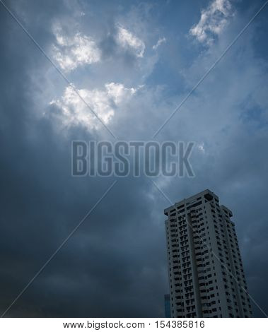 A BUILDING WITH DARK STORMY SKY IN THE BACKGROUND
