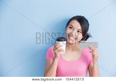 woman hold coffee with dental table isolated on blue background
