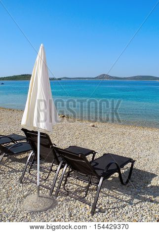 Sun loungers on the pebble beach in Vodice in Croatia.