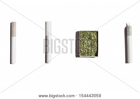 Cigarettes with weed.Open box with hemp one empty cigarette and two filled with tobacco and cannabis isolated on white background.