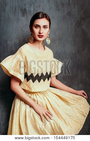 Gorgeous girl dressed in yellow beautiful suit