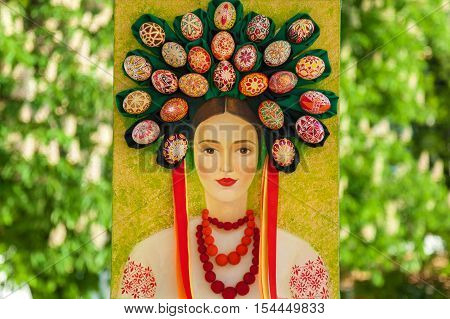 Kyiv Ukraine Sophia Square - 2 of May 2016. Easter composition. Ukrainian Easter portrait of a woman in traditional suit and circlet of painted eggs on her head.