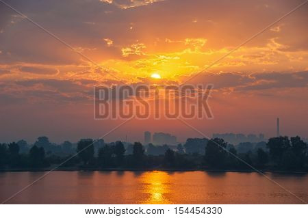 Sunset in the city.Beautiful evening sunset with reflection over the river and city skyline.