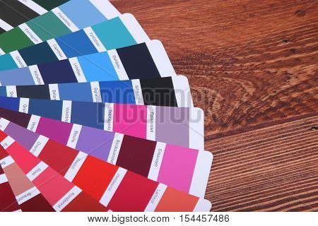 collection of ral colours on wooden background. colored paper