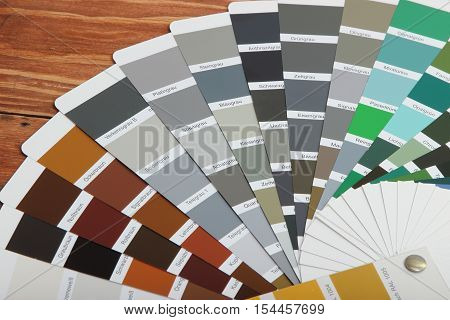 collection of ral colours on wooden background. colored paper