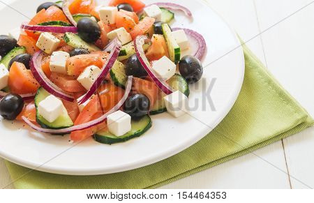 Classic greek salad. Salad with tomato cucumber red onion black olives and fresh feta cheese selective focus horizontal