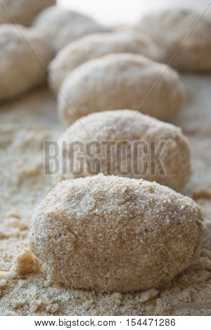 preparation of sicilian arancine with breadcrumbs on a paper