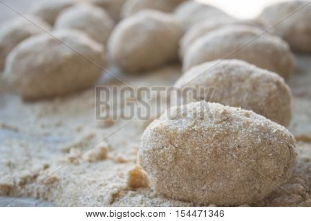 preparation of sicilian arancine with breadcrumbs on a paper