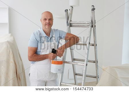 Portrait Of Decorator Painting Room In House