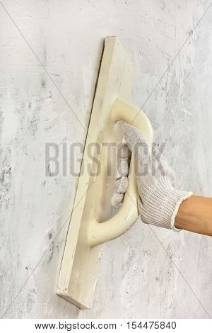 hand plastering concrete wall with trowel during repair
