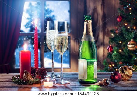 close up view of two glasses with champagne and candles on color back
