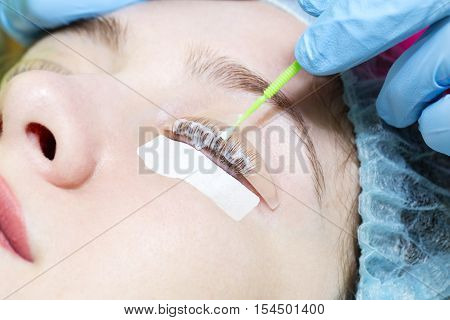 Woman on the procedure for eyelash extensions, eyelashes lamination