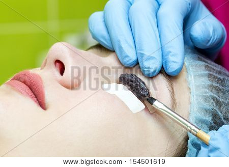 Woman on the procedure for eyelash extensions, eyelashes lamination