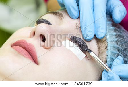 Woman on the procedure for eyelash extensions, eyelashes lamination