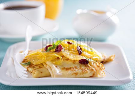 Crepe suzette for breakfast with orange cranberry sauce