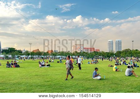Bangkok, Thailand - December 4, 2015: Unidentified people come to Sanam Luang for relax and picnic on the grass. It is the open field in the front of Grand Palace in Bangkok Thailand.