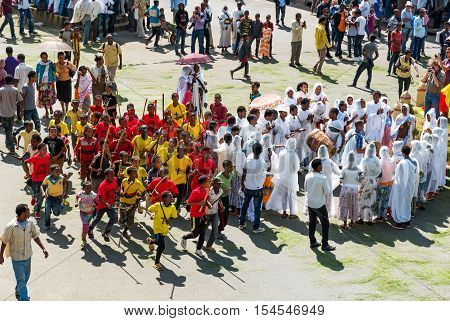 Gondar Ethiopia - January 19 2016: A crowd of faithful and tourists surrounding a procession in the annual religious celebration of Timket (epiphany)