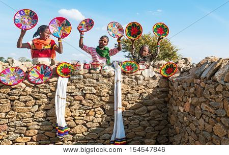 Axum Ethiopia - January 20 2016: Joung craft vendors between the ruins of the baths of the Queen of Saba