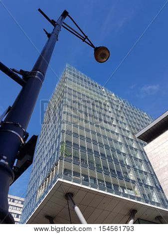 Street lamp. modern lamppost against modern building facade in daylight in Manchester UK