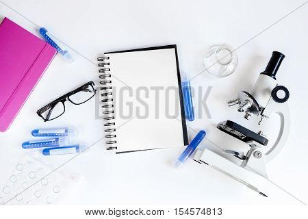 medical student working place with blank open notebook space for text top view