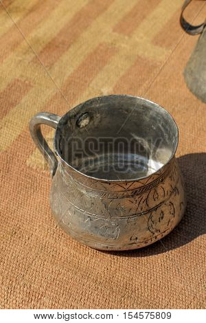 Selling old metal cookware in a bazaar