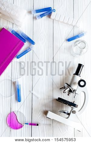 doctor workplace at wooden table with microscope in lab top view no one