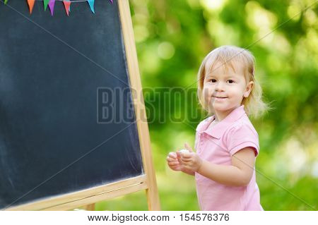 Adorable Toddler Drawing With A Chalk