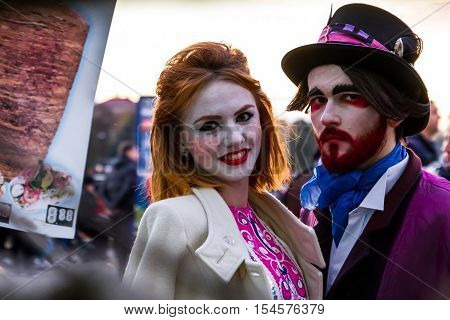 Uzhgorod Ukraine - October 31 2016: Participants in the celebration Funny Halloween in the image of of porcelain dolls and a demon waiting for the start of the procession of representatives of evil forces in the city center.