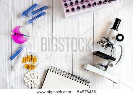 workplace lab assistant with microscope at the clinic top view no one