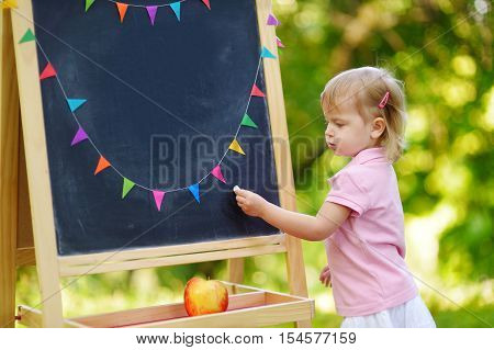 Adorable Toddler Drawing With A Chalk